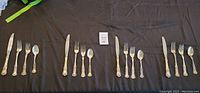 Wide layout of all flatware on black cloth