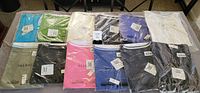 Twelve sealed Talbots women's t-shirts in assorted colors displayed on table
