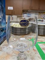 Close-up image of one Bohemia Crystal wine glass showing the label sticker on the bowl, clear crystal, and rounded bowl shape.