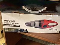 Box of AUTOHAUS handheld wet and dry car vacuum cleaner showing product image and branding.