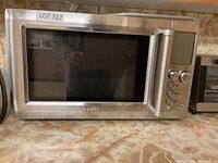 Front view of stainless steel Breville microwave with digital control panel and handle.