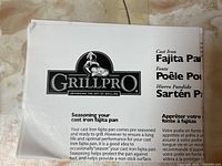 Instruction sheet showing GrillPro brand cast iron fajita pan seasoning information.