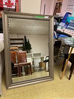 Front view of the framed mirror showing size, frame style, and condition.