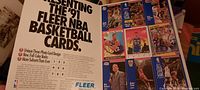Close-up photo of one of the 1991 NBA basketball card ads showing player cards from that season including Patrick Ewing.