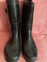 Front view of the black rain boots showing rounded toe and shaft height.