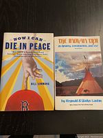 Two books side-by-side on a dark surface, showing full front covers and titles.