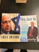 Cover photo showing both books in the lot: "Ariel Sharon: A Life" and "This Just In" by Bob Schieffer