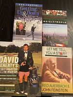 Four books stacked or arranged showing covers and titles.