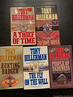 Photo showing all 5 Tony Hillerman paperback books front covers together on a dark surface.