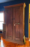 Full front view of wardrobe showing double doors and moulding