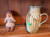 Photo of both ceramic figure and pitcher showing general size and style