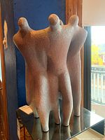 Side view of the abstract figurative ceramic statue showing four tall figures standing together. Rough textured surface and muted earthy tones visible. Piece signed and dated 1964 per seller description.