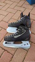 Side view of CCM Custom 01 men's hockey skate size 5 showing black boot with gray and white accents, white blade holder with CCM logo.