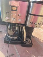 Full view of Cuisinart coffee maker showing dual brewing units and glass carafe.