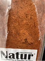 Close up of natural cork plank showing texture and brand Natur Collection