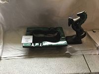 Green and black glazed geometric pottery ashtray and black horse figurine set on shelf