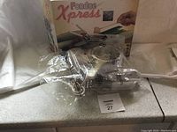 New Fondue Xpress fondue set sealed in plastic with original box in background