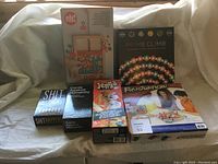 Photo showing six boxed games including Jenga, Prime Climb, Frustration, Oh Snap!, and two Cards Against Humanity decks