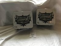 Two Orange County Choppers metal lunch boxes with logos, both showing wear and damage.
