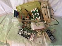 Overview of lot showing hair dryer, massager, shredder, and sewing supplies in green storage case