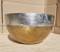 Side view of the large glass bowl showing the silver and gold leaf finish.