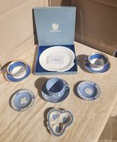 Photo showing entire set with blue and white Wedgwood tea cups, saucers, plates, ashtrays, and clam shell plate with box