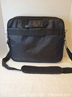 Front view of the Dell black nylon professional briefcase showing adjustable shoulder strap with pad and top handle.