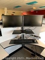 Front view of the workstation with two monitors mounted side by side over the keyboard tray on the dual monitor sit-stand desk converter.