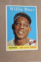Front image of 1958 Willie Mays card showing player portrait, team San Fran Giants outfield, and card number #5 with visible wear on edges and corners.