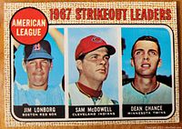 Front of the 1967 Topps baseball card #12 showing the top three American League strikeout pitchers Jim Lonborg, Sam McDowell, and Dean Chance with their teams noted.
