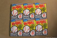 Front view of six sealed 1989 Fleer Baseball wax packs arranged in two rows of three, showing colorful branding and baseball graphics on the packaging.