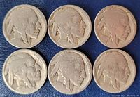 Obverse side of six Buffalo nickels showing Native American profiles with heavy wear and no readable dates.