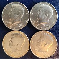 Obverse side showing the date 1967 and profile of John F. Kennedy on four half dollar coins.