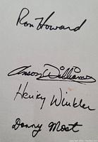 Photo of printed autographs of Ron Howard, Anson Williams, Henry Winkler, and Donny Most on the back of postcard.