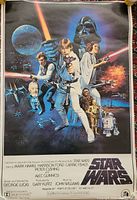 Front of original 1977 Star Wars movie poster featuring main characters and Star Wars logo.