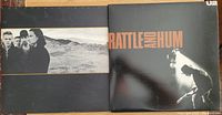 The front covers of two U2 vinyl albums: The Joshua Tree and Rattle and Hum.