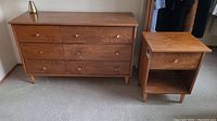 Full view of dresser and matching nightstand on carpeted floor, lamp excluded
