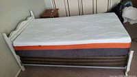 Side view of assembled bed frame with mattress and box spring