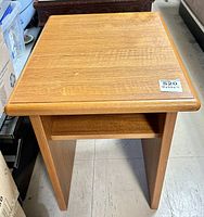 Top view of the teak side table showing wood grain and surface detail with a measurement sticker.