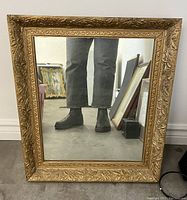 Front view of antique gilt wood framed hall mirror showing overall condition and detailed carved frame