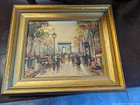 Front view of the framed oil painting showing the Paris street scene and artist signature.