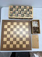 Top view of both chess boards and open box with chess pieces separated inside