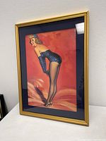 Front view of the framed pin-up lady art print showing the subject and gold frame