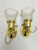 Front view of pair of polished brass drop shade wall light sconces with turn key switches, wired and ready to use.