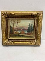 Front view of the oil painting showing the scenic landscape in ornate gilt wood frame.