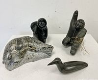 All four soapstone Inuit sculptures grouped together showing size and details