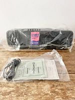 Hitachi TRK-640HC cassette radio new in plastic wrapping, showing stereo speaker grills and top controls.