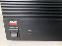 Front panel lower left showing ADCOM logo, model GFA-565 label, rectangular power switch and red LED power indicator.