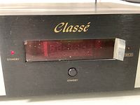 Close-up of front panel showing gold Classe logo, standby LED and red display window