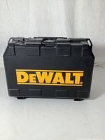 Closed black hard plastic case with large yellow DeWalt logo on the front.
